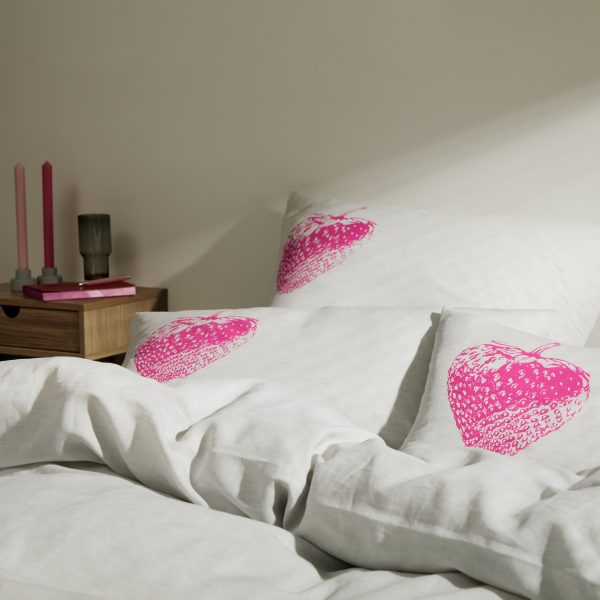 Frohstoff verschiedene Kissen mit dem Erdbeeren-Motiv im Fabrton neon-pink in einem Bett dekoriert