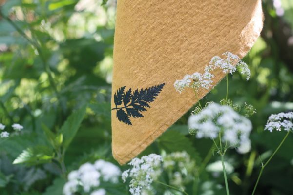 Frohstoff Serviette aus Leinen Honiggelb mit Kerbelblatt-Motiv. Natur im Vorder und Hintergrund